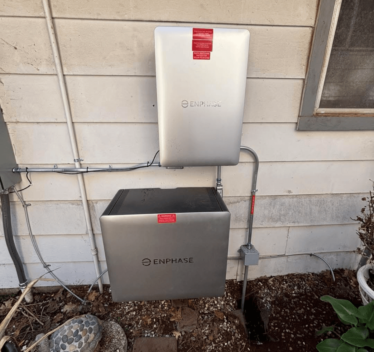 Enphase battery and solar equipment mounted beside conduit